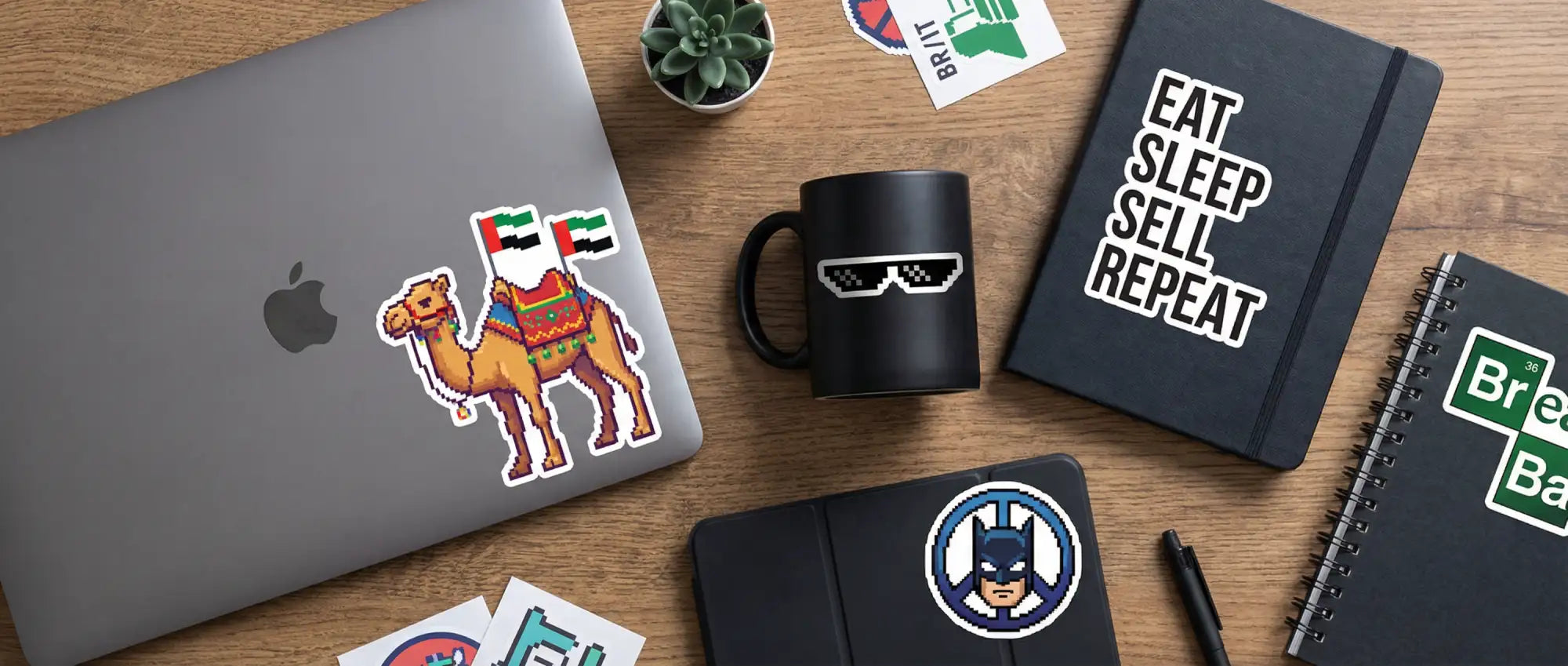 Gray laptop with a pixelated camel sticker featuring the uae flag on its back